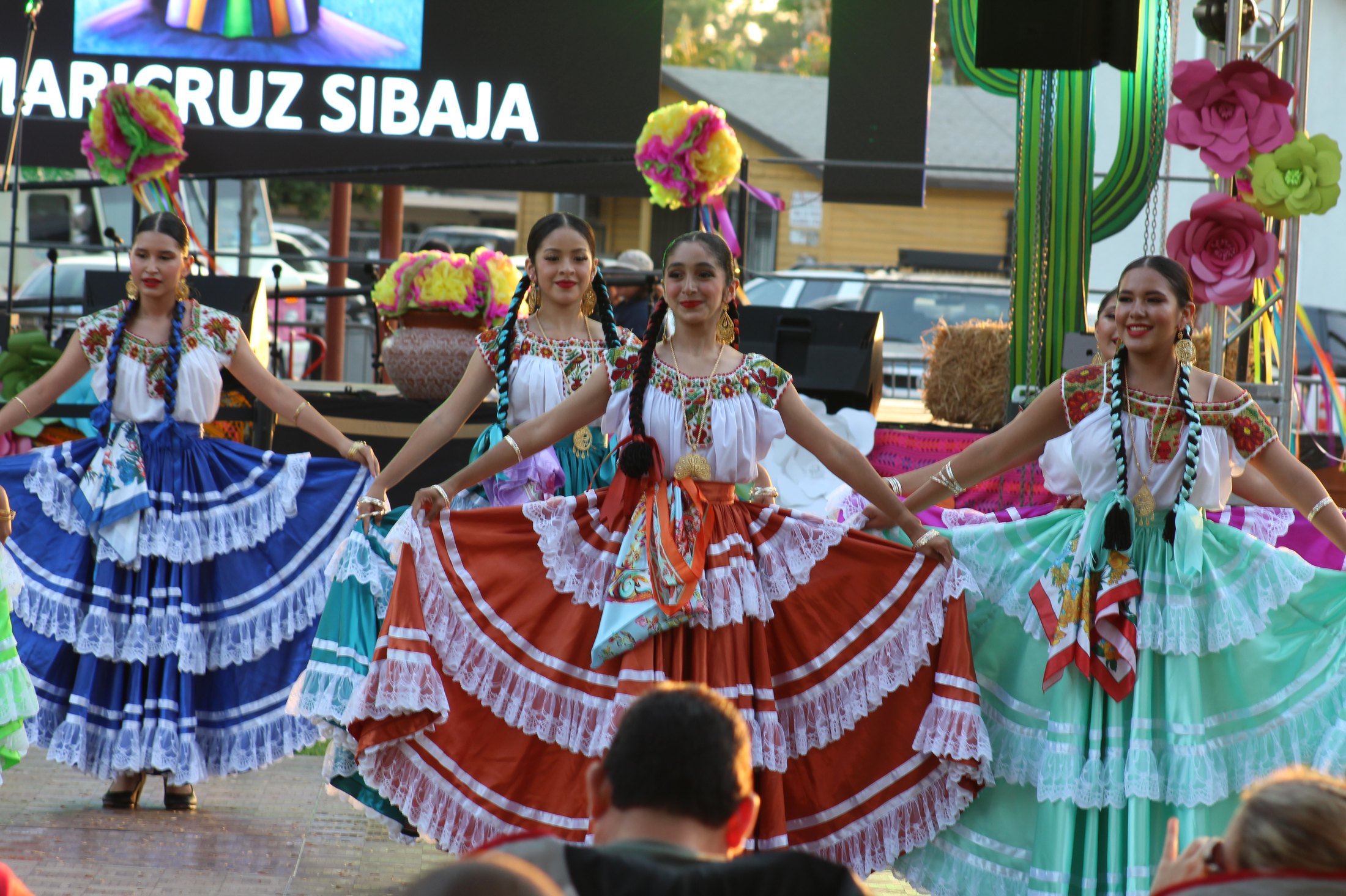 TAF dancers outdoors in colorful dresses